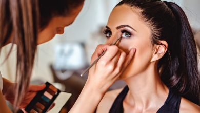 Makeup artist applying eyeshadow on a girl