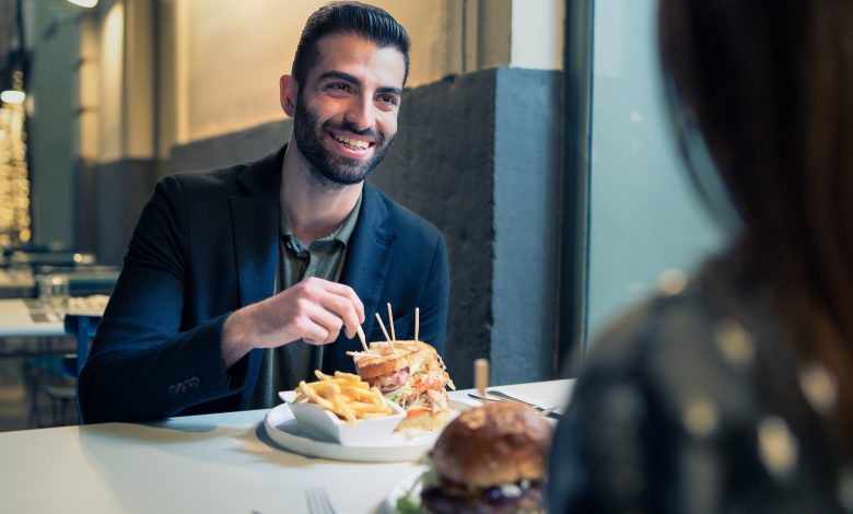 Portrait,Of,A,Bearded,Young,Man,Eating,Chips,And,Sandwiches