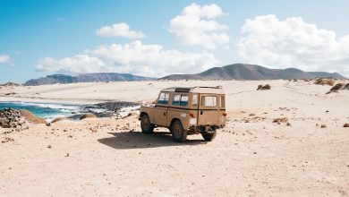 shot of an off-road car standing in a wild area by a small lake