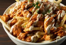 A,Closeup,View,Of,A,Bowl,Of,Chicken,Shawarma,Fries.